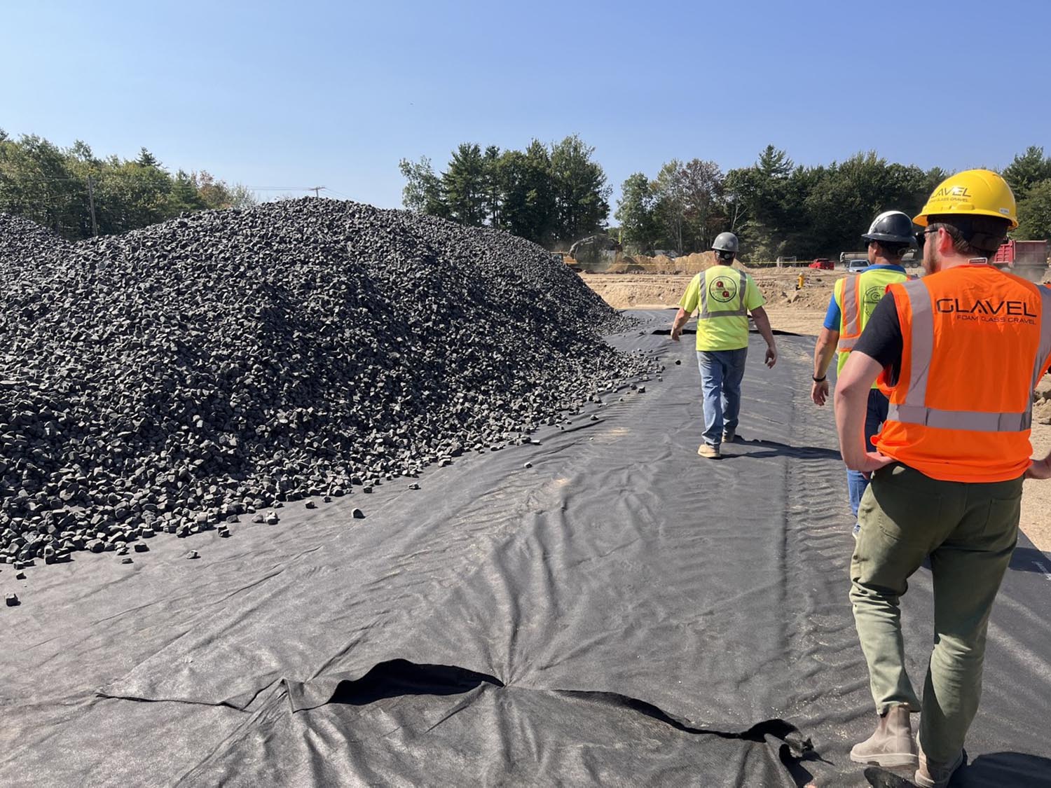 Inspecting Glavel foamed glass aggregate on a job site.